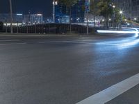 a city street filled with lots of traffic at night time - side light trails from a traffic signal