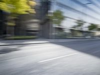 a view of a city street from a moving car lens with a blurry background