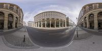 a street view from the bottom of the street with buildings on both sides of it and a curved sidewalk with a paved street,