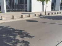 a group of cement dividers along a street with a street light on either side