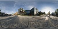 a fish eye lens view of an empty street and buildings on the opposite side of it