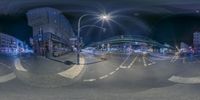 a 360 view of city streets at night time with lights on, the sky is filled with stars