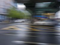 a blurry view of buildings in a city during the day time time and a rainy day