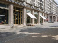 the side walk has awnings on two sides that allow shade to the sidewalk