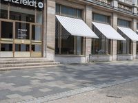 the side walk has awnings on two sides that allow shade to the sidewalk