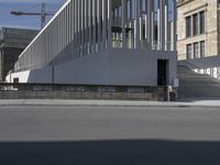 a person is riding a bike in front of a building with a ramp behind them