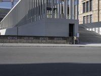 a person is riding a bike in front of a building with a ramp behind them