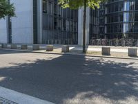 the person on the sidewalk using their cell phone while riding his skateboard along the street