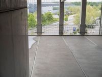 empty walkway leading from building to parking lot, outside window with doors open and view