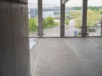 empty walkway leading from building to parking lot, outside window with doors open and view