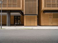 an empty street in front of a building with shuttered doors and windows that allow air parking and access