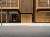 an empty street in front of a building with shuttered doors and windows that allow air parking and access