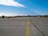 an empty air port and an airport runway on a sunny day with many traffic barriers