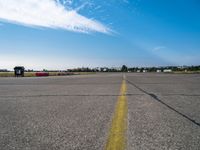 an empty air port and an airport runway on a sunny day with many traffic barriers