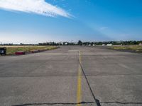 an empty air port and an airport runway on a sunny day with many traffic barriers