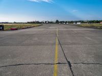 an empty air port and an airport runway on a sunny day with many traffic barriers