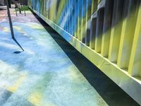 a child's playground with blue, yellow and red paint all over the surface