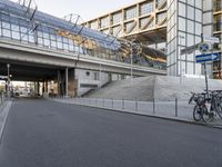 the parking lot for an indoor gym building near a street, which contains a walkway and stairs