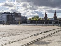 a river view looking at buildings near water and some tracks running beside the river edge