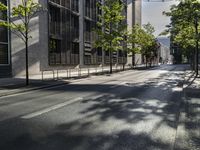 two parked bikes on the side of an empty street in city city area, near building