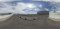 a fish eye lens picture of a curved roadway in an urban area with skyscrapers and modern buildings