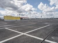 empty parking lot in a car park under a cloudy sky with white clouds above it