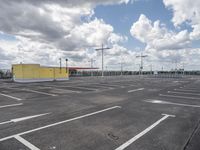 empty parking lot in a car park under a cloudy sky with white clouds above it