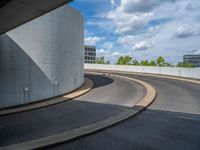 a car is driving on the highway through an underground parking garage area in a city