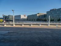 a street and a building in the distance with a bench on it's side