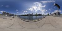 an artistic photo of the lake and sidewalk from a fish - eye lenser's perspective