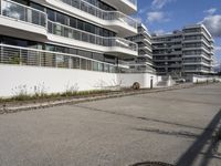 this is a road lined with a building that has many balconies on top