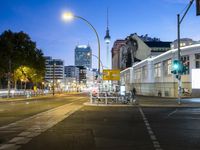 a street with a few street lights and an office building in the background at night