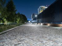 a sidewalk with cobblestones that look like stone floors at night in a european country town