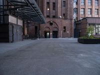 a walkway leads to a building and a gated entrance on both sides of the road