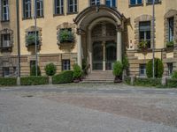 large yellow building with some plants and bushes in front of it for decoration or entertainment