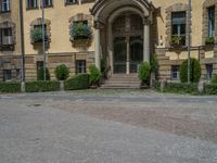 large yellow building with some plants and bushes in front of it for decoration or entertainment