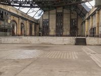 the empty building with stairs leading up to the entrance and an archway, at the center of which is a stair way