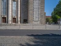 an entrance of a building with large columns and doors that spell out the word voltege