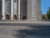 an entrance of a building with large columns and doors that spell out the word voltege