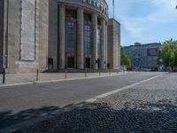 an entrance of a building with large columns and doors that spell out the word voltege