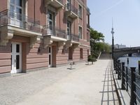 a row of buildings that have balconies on them by the water's edge