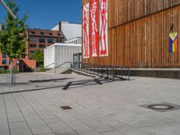 a group of people riding skateboards near wooden panels and stairss with artwork on them