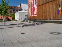 a group of people riding skateboards near wooden panels and stairss with artwork on them