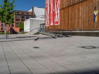 a group of people riding skateboards near wooden panels and stairss with artwork on them