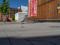 a group of people riding skateboards near wooden panels and stairss with artwork on them