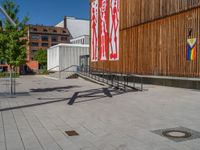 a group of people riding skateboards near wooden panels and stairss with artwork on them