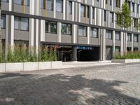 an open doorway and parking garage next to a building with a flag hanging from it's roof