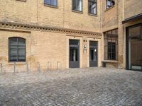 the entrance of a building on a cobblestone street in london, england stock photo