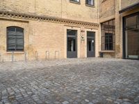 the entrance of a building on a cobblestone street in london, england stock photo