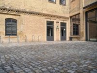 the entrance of a building on a cobblestone street in london, england stock photo